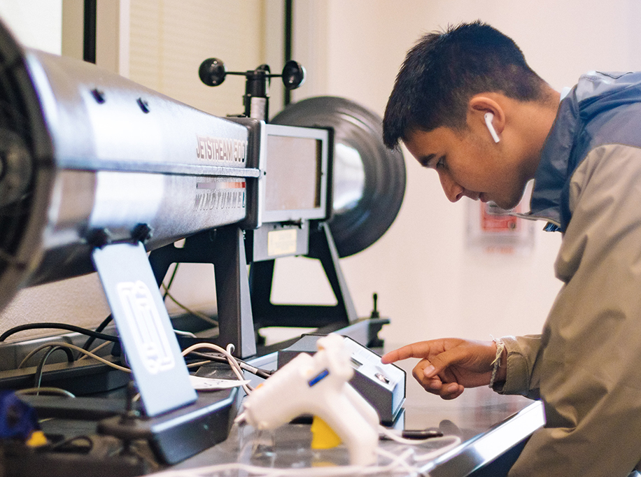 boy in front of mmachine with earpods in