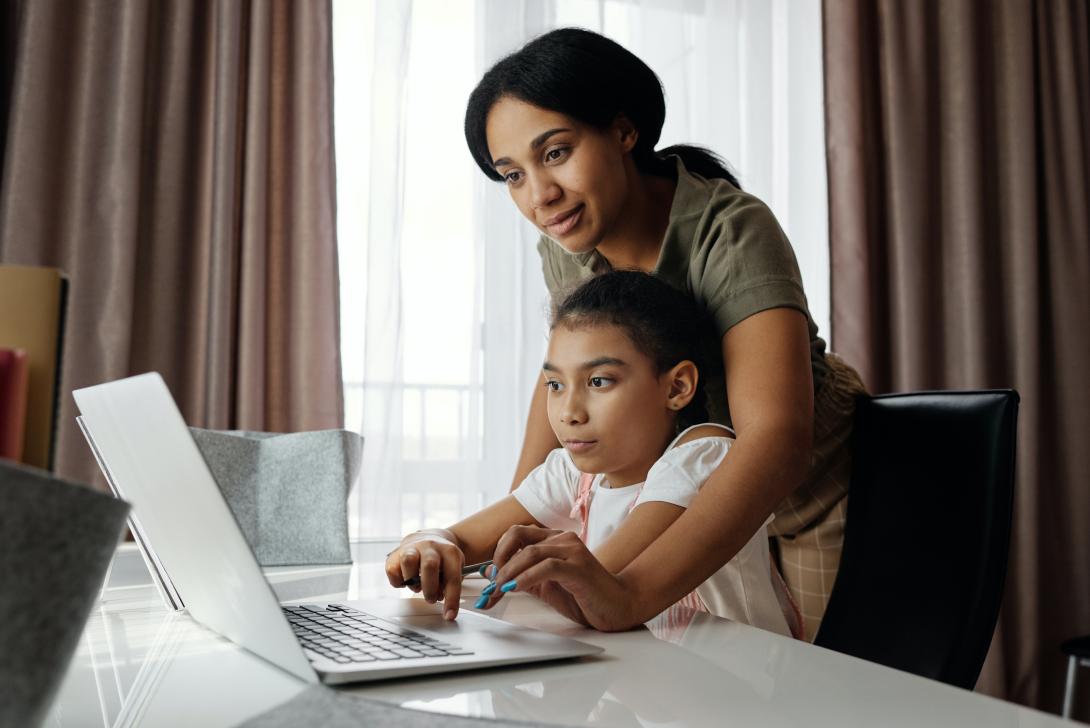 Parent and child working on a computer together