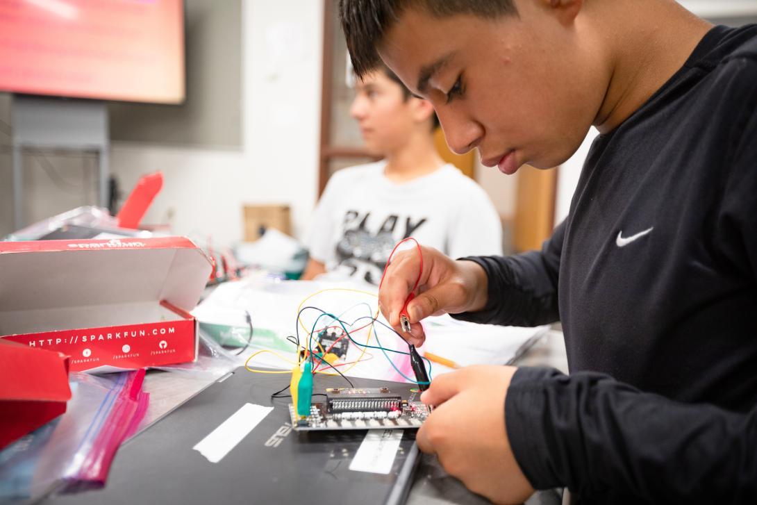 student adjusting electrics project