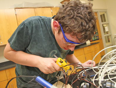 A Minooka student working on his underwater robot