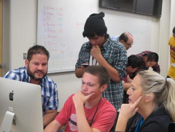 High school students and teachers working collaboratively in the Power Track Design Village in the first Project AMP cohort.